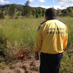 Rural Fire Service officer tests the grass for burning