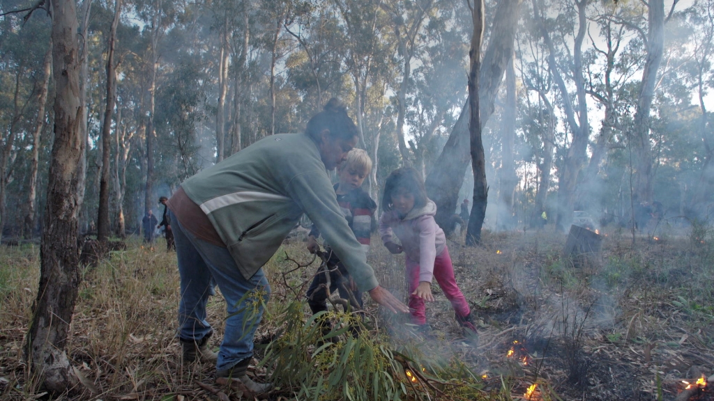 Vanessa Cavenagh with Jarjum (her children), Tyson and Emma Cavanagh at the 2019 National Indigenous Fire Workshop, Dhungala hosted by Yorta Yorta. Photo courtesy of Craig Bender and Vera Hong.